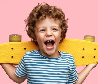 Pediatric Cavity Treatment - Boy holding skateboard.